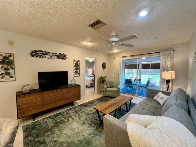 Tiled living room with ceiling fan