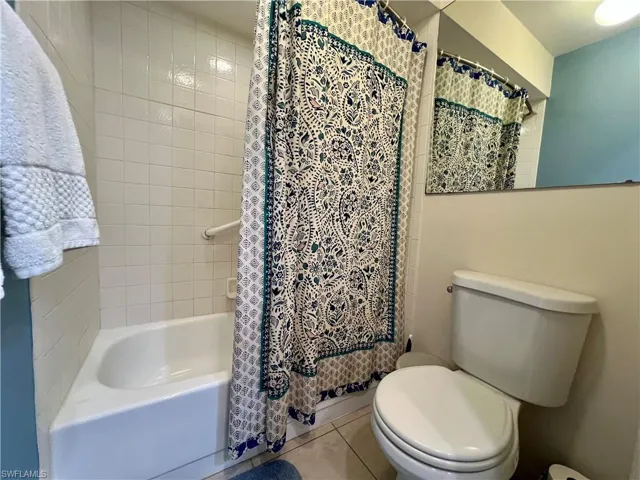Shower/Tub combo with shower curtain, and toilet