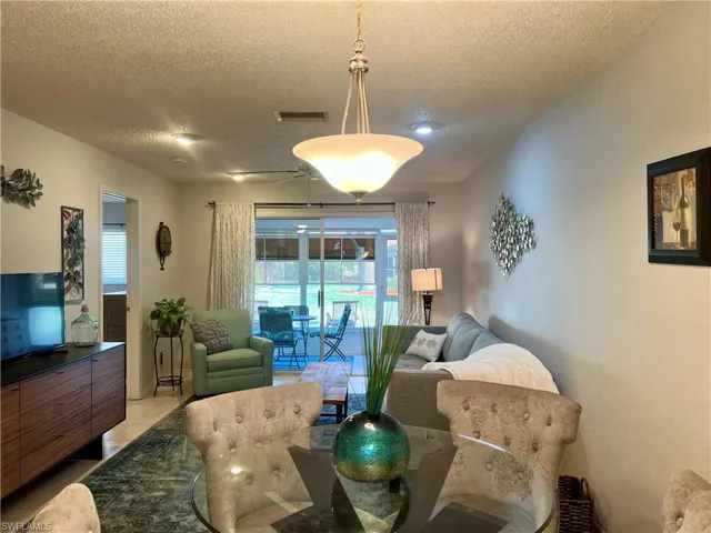 Tiled Dining room with a textured ceiling