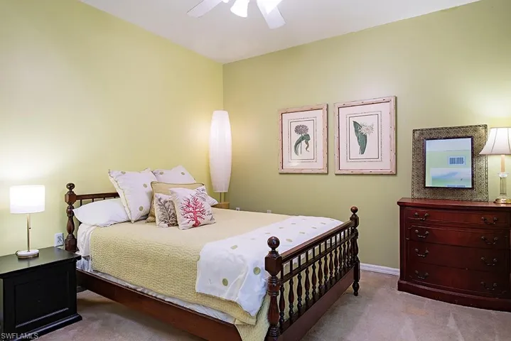 Carpeted bedroom with ceiling fan