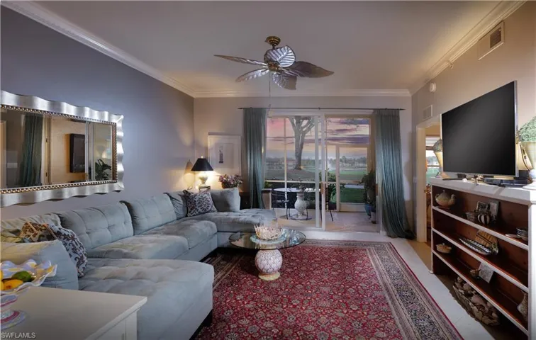 Living area at Dushk with crown molding and ceiling fan