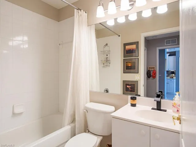 Full bath featuring shower / tub combo with curtain and vanity