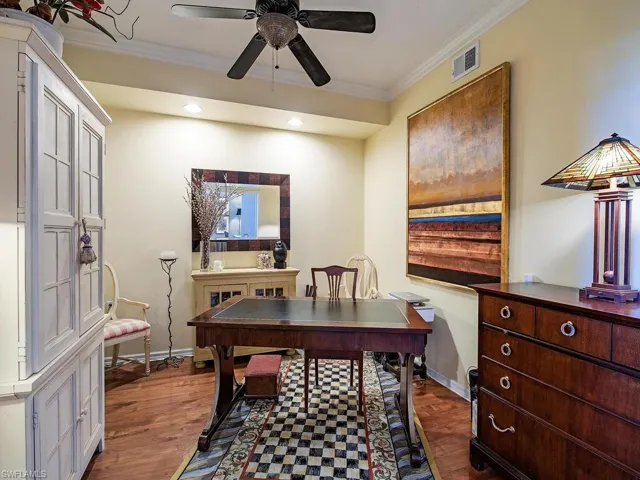 Office area featuring ornamental molding, dark wood-type flooring, and recessed lighting