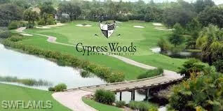 Surrounding community featuring view of golf course, a yard, and a water view