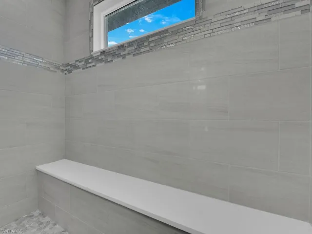 Full bath featuring a tile shower
