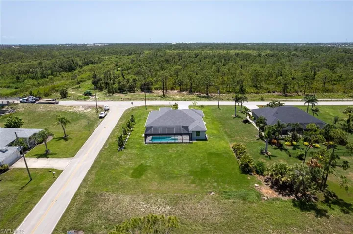 View of subject property with a forest