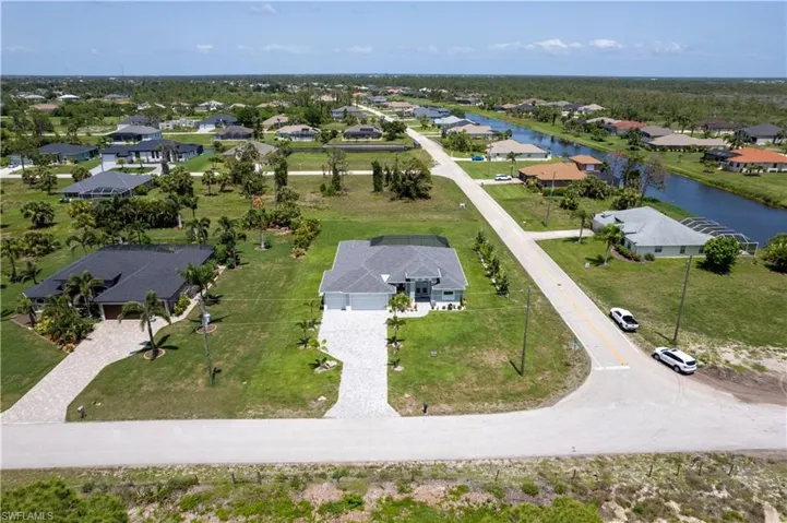 Aerial perspective of suburban area with a large body of water