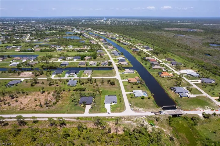 View of property location featuring a nearby body of water and nearby suburban area