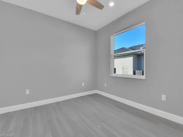 Empty room featuring wood finished floors, a ceiling fan, and recessed lighting