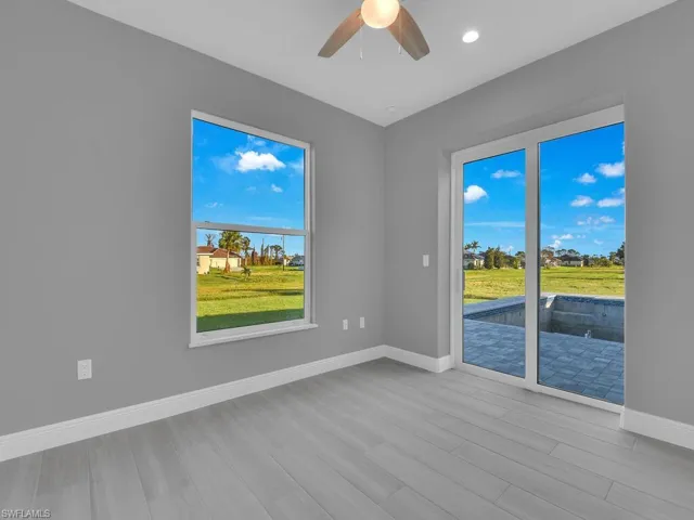 Unfurnished room featuring wood finished floors, ceiling fan, and recessed lighting