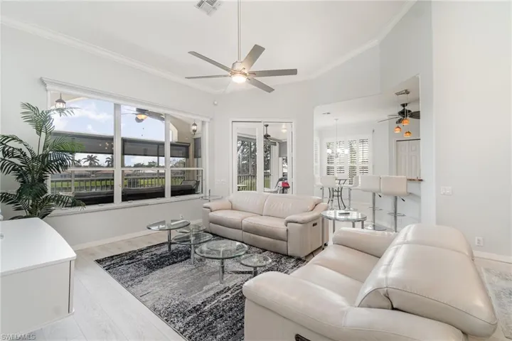 Living area with view of lanai and golf course