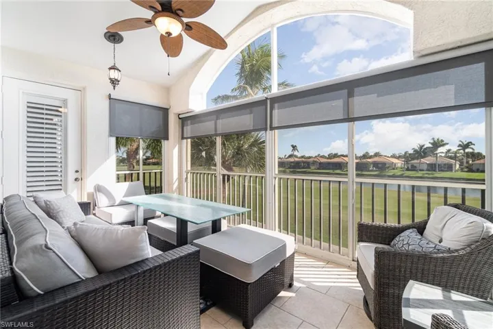 Oversized lanai featuring a water view, ceiling fan, and vaulted ceiling