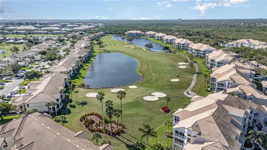 Drone / aerial view with a water view, a residential view, and golf course view
