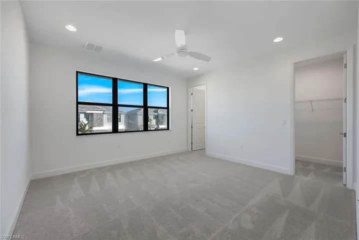 Second Floor Bedroom with ceiling fan and light carpet