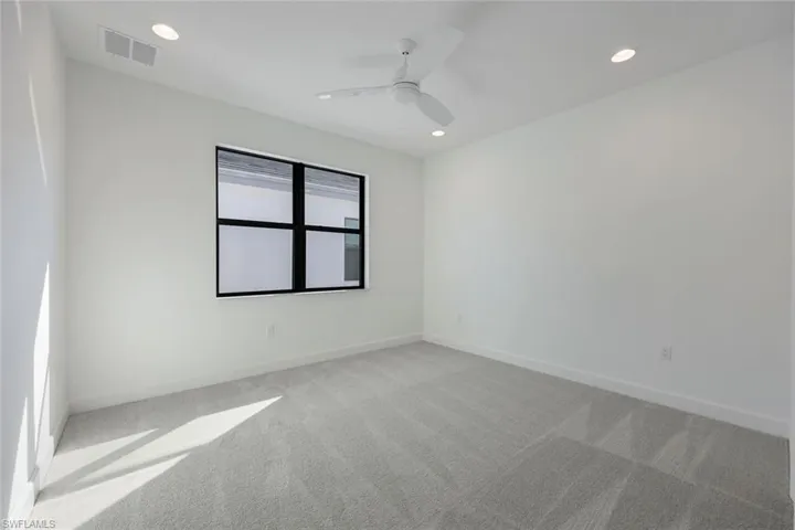 Bedroom on second floor with carpet and ceiling fan