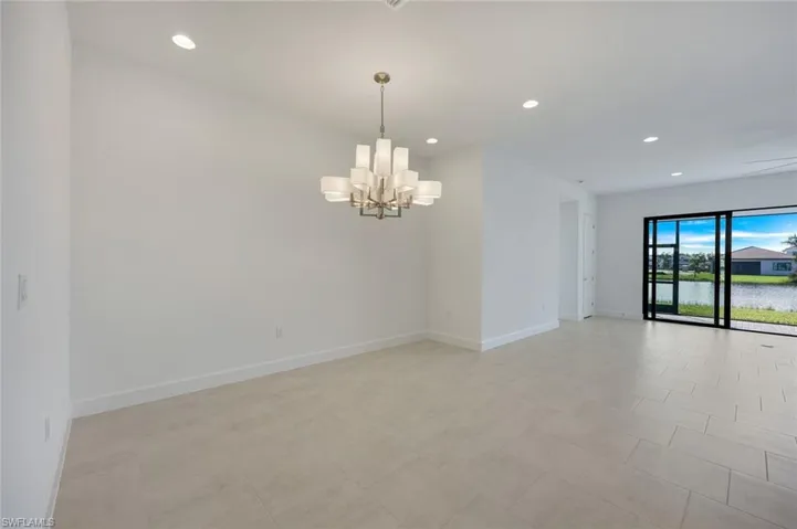 Dining room featuring with notable chandelier and views of Living Room and Lanai