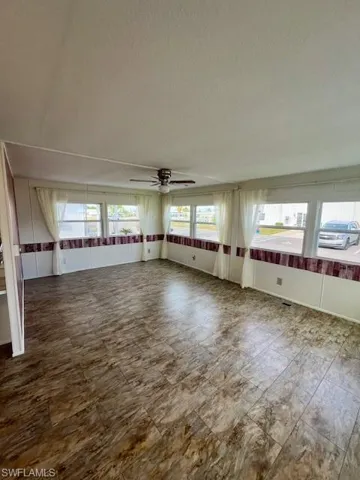 Empty room with a ceiling fan and a textured ceiling