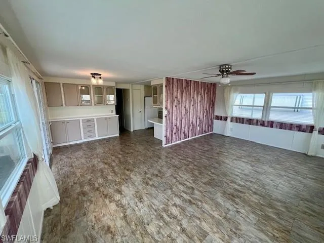 Unfurnished living room with a ceiling fan