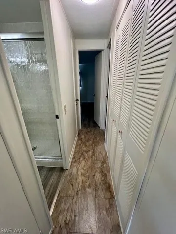 Hallway featuring wood finished floors