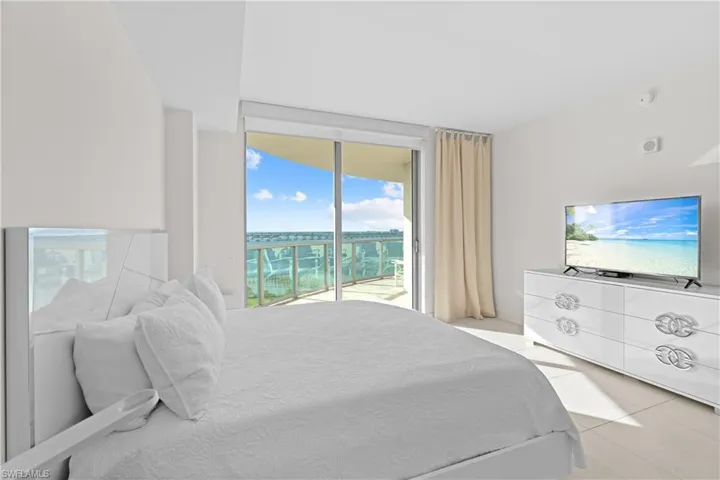 Bedroom with access to outside and light tile patterned floors