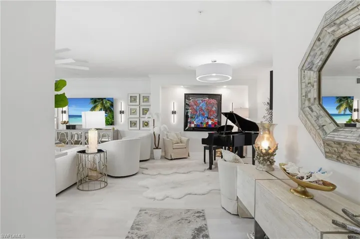 Bright interior space featuring light wood-finish flooring, recessed lighting, and a drum pendant light fixture