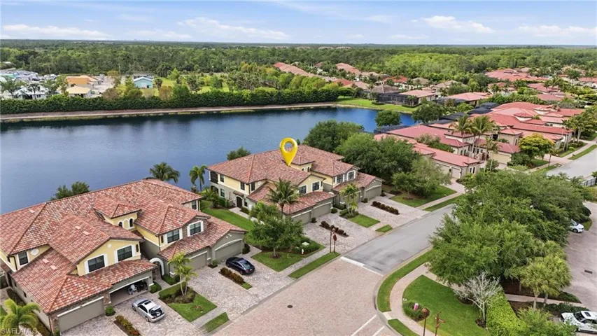 Aerial perspective showcasing a residential community with water features and mature landscaping