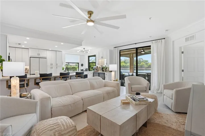 Open-concept living area with a large ceiling fan, recessed lighting, and light wood-finish flooring