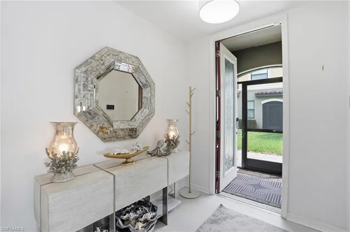 Entryway featuring light-toned flooring and white walls