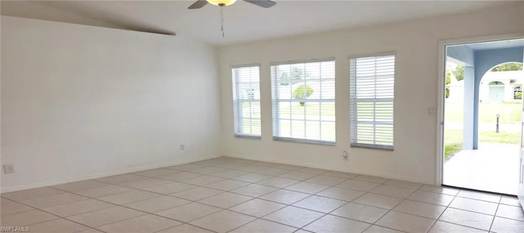 Tiled spare room with ceiling fan