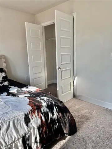 Bedroom # 4 featuring baseboards, a closet, and carpet flooring