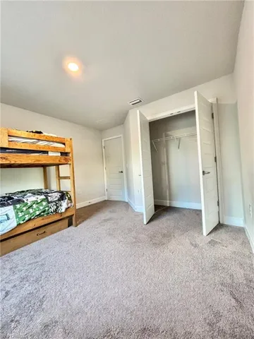Bedroom #3, featuring baseboards,  a closet, and carpet