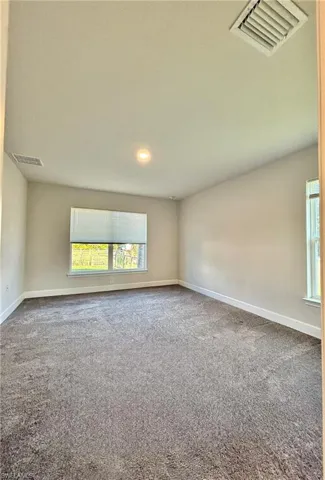 Master Bedroom  featuring a wealth of natural light, visible vents, and baseboards