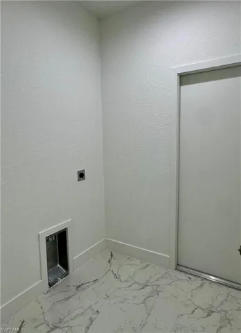 Laundry area featuring light marble finish floors and electric dryer hookup