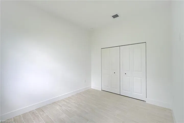 Unfurnished bedroom with light wood-style floors and a closet