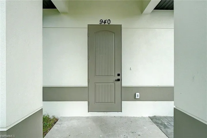 Doorway to property with stucco siding