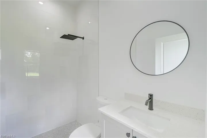 Bathroom featuring vanity and tiled shower