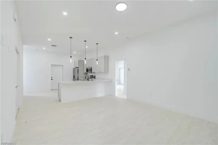 Unfurnished living room featuring light wood finished floors and recessed lighting