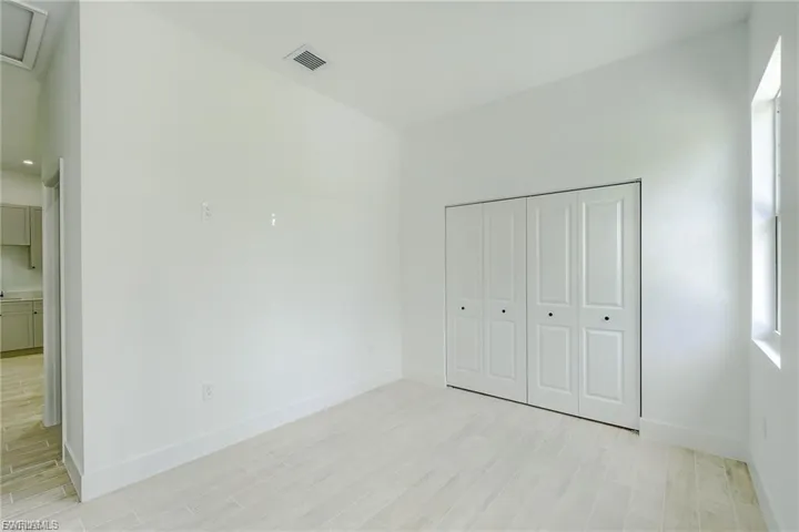 Unfurnished bedroom with light wood finished floors and a closet