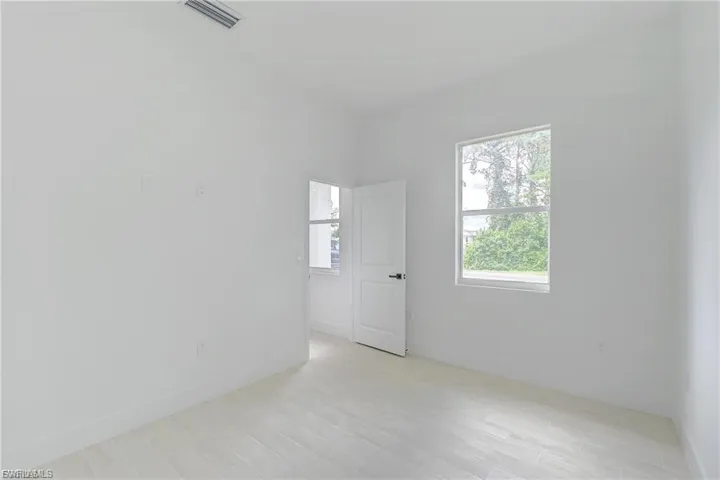 Unfurnished room with light wood-type flooring and baseboards