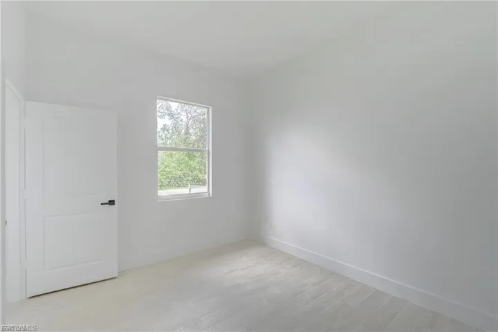 Empty room with light wood finished floors