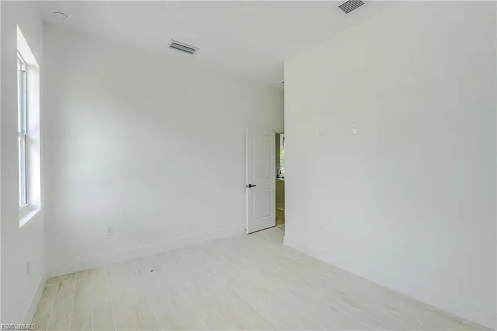 Unfurnished room featuring light wood-type flooring and baseboards