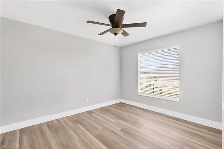 Unfurnished room with light wood-style floors and a ceiling fan