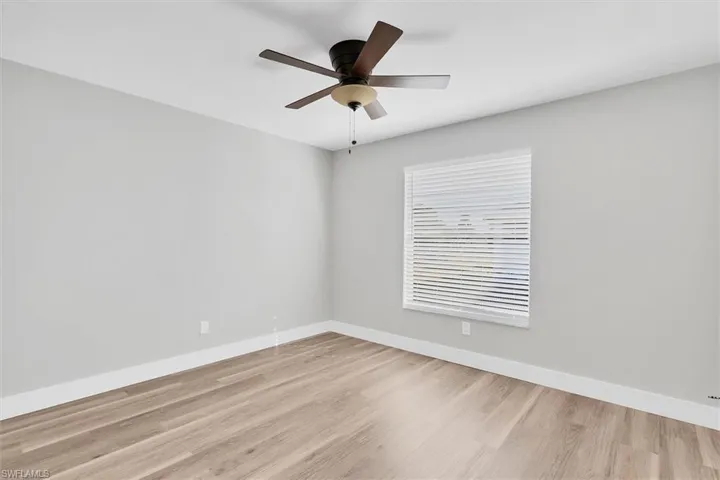 Spare room with light wood-style floors and a ceiling fan