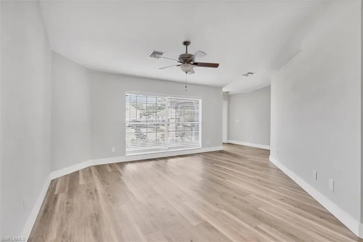 Empty room featuring light wood-style floors and ceiling fan