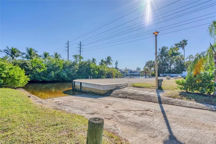 View of community featuring a boat ramp, a water view, and a dock