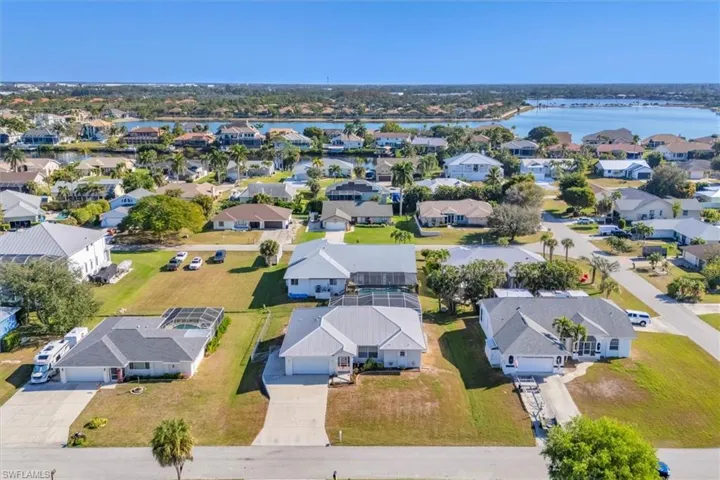 Aerial perspective of suburban area with a large body of water