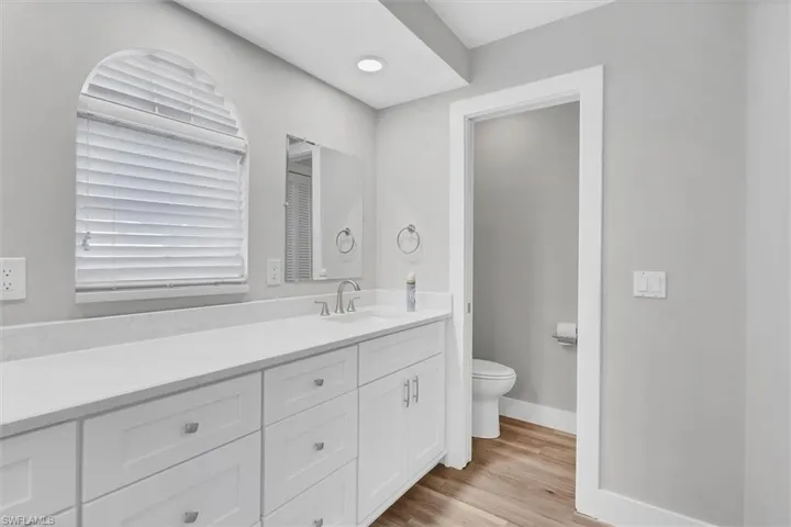 Full bathroom with vanity and light wood finished floors