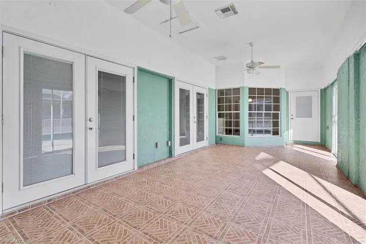 View of patio / terrace with ceiling fan, french doors, and a sunroom