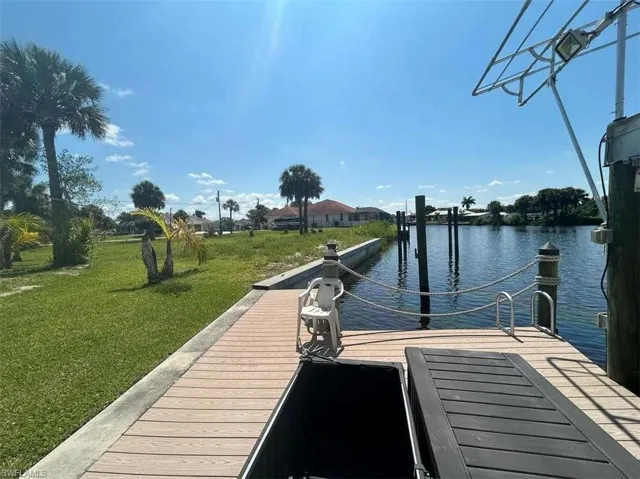 View of dock featuring a water view and a yard