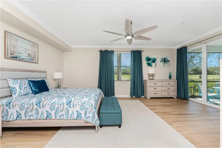 Bedroom with ornamental molding, light wood-style flooring, access to exterior, and a ceiling fan